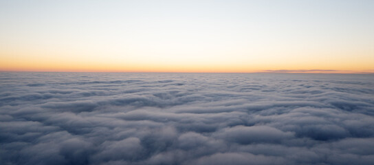 Fototapeta na wymiar Wonderful morning landscape. The sun rises over the fog. Sunset over the clouds.