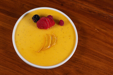 Orange citrus dessert with berries