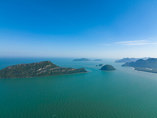 lonely faraway, the empty ocean seperate half frame water and cloud blue sky with little island town