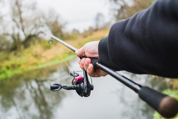 Fisherman throws spinning first person view. Photo of the hand of a fisherman throwing spinning