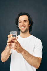 man glass of water in his hands emotions posing beige background