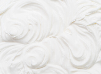 Creamy waves and swirls in yoghurt or cream surface. Top view.