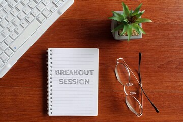 Top view image of keyboard, glasses and notebook with text BREAKOUT SESSION.