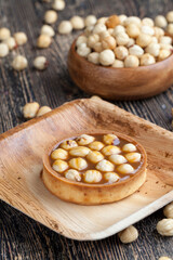 round tartlet with soft caramel and roasted hazelnuts
