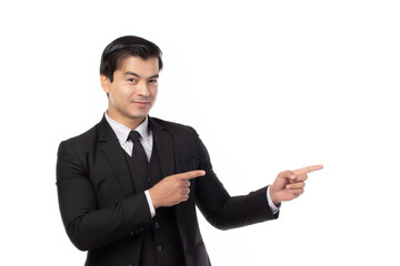 Portrait of a confident business man in black suit smile and pointing to copy space isolated on white background. Portrait business concept.