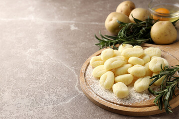 Concept of cooking potato gnocchi on gray textured background
