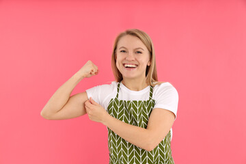 Girl power concept with young woman on pink background