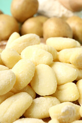 Concept of cooking with raw potato gnocchi, close up