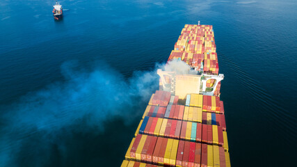 Stern of large cargo ship with Smoke exhaust gas emissions from cargo lagre ship ,Marine diesel...
