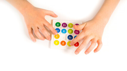 Hands of a child playing a board game