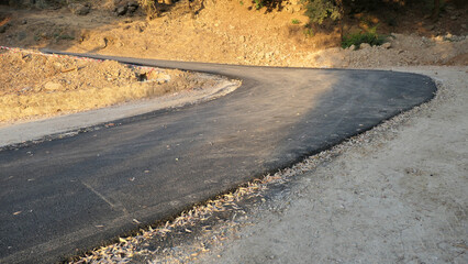 Newly tarmacked road on rural hillside