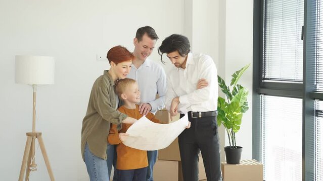 Family And Real Estate Agent In Formal Suit Communicating While Examining Blueprints , Family Going To Get Mortgage, In Bright Interior Room, At Home Indoors