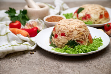 Delicious chicken aspic on a plate on concrete table