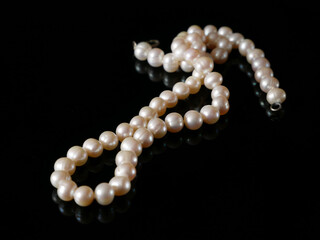 beautiful pearls necklace on black background, pawnshop concept, jewerly shop concept