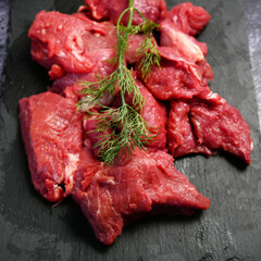 tenderloin veal meat for steaks fillet mignon on black board. Top view.