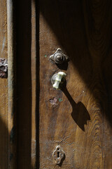 Old lock with a round door knob on a weathered wooden gate