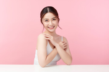 Beautiful young asian woman with clean fresh skin on pink background, Face care, Facial treatment,...
