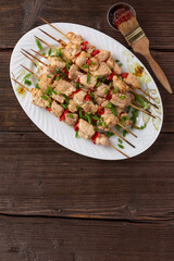 BBQ picnic with kebabs and meat on an open fire on a summer day in the backyard of a private house.