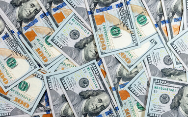 One hundred dollar bills background. American dollars heap. Concept of doing business and financial...