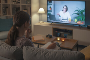 Woman watching a nutritionist talking on the TV