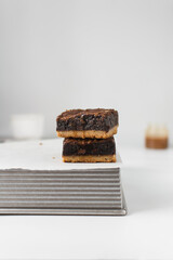 fudgy brownies on a metal pan, fudgy caramel brownies with a cookie crust, stack of brookies, thick brownie bars