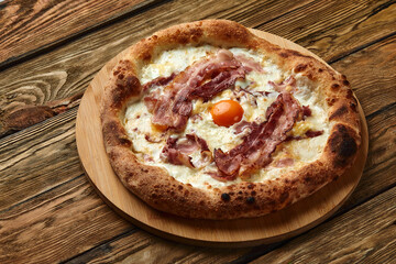 Carbonara pizza with bacon and egg on wooden background