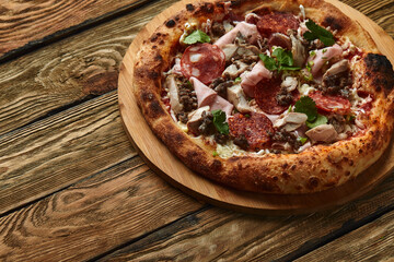 Meat Italian pizza with roast beef, steak slices, melted cheese, with olive slices and cheddar cheese. Close up, macro. Pizza time concept.