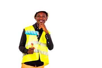 young man painter holding a brush roller smiling.