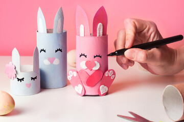 Handmade Easter decoration cute little rabbit. Art from paper tube Reuse concept. Making cute bunny DIY for kids.