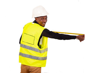 young man carpenter measuring the wall with tape measure smiling.