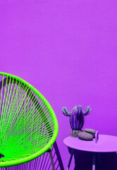 Summer armchair against purple wall. Home decor in detail. Minimalist aesthetic. Very peri trends