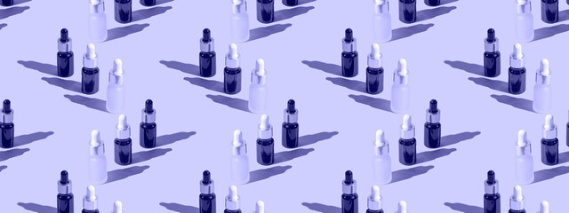 Cosmetic bottle mockup with cosmetics on very peri background with hard shadows, copy space closeup.  pattern