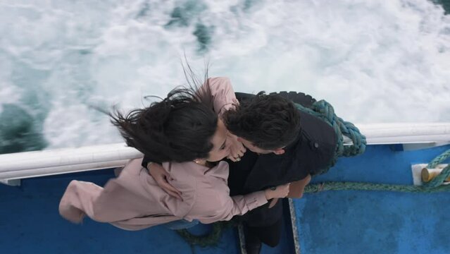 couple hugging while riding a boat