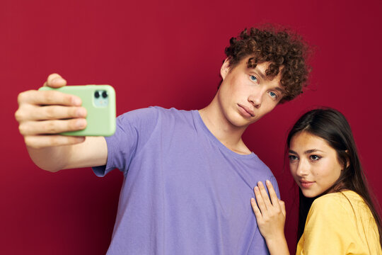 a young couple take a selfie posing hug isolated background