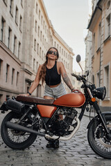 Fototapeta na wymiar Confident woman hipster with old fashioned bike outdoors