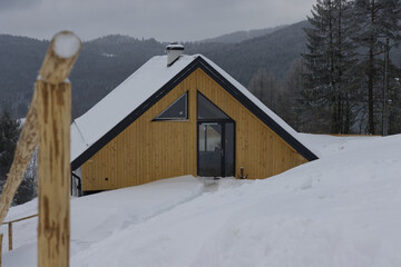 Village house in the mountains covered by high snow