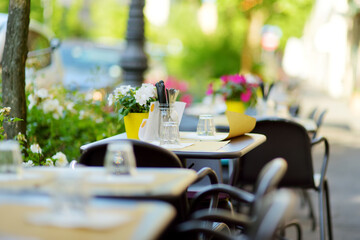 Outdoor cafe table in medieval Lucca town, famous for its intact Renaissance-era city walls and...