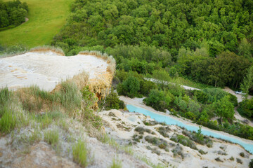 Natural swimming pool in Bagno Vignoni, with thermal spring water and waterfall. Geothermal pools and hot springs in Tuscany, Italy.