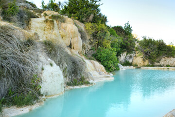 Natural swimming pool in Bagno Vignoni, with thermal spring water and waterfall. Geothermal pools...