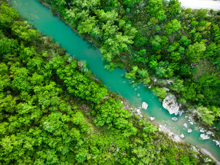 Fototapeta na wymiar Aerial view of natural swimming pool in Bagno Vignoni, with thermal water and waterfall. Geothermal pools and hot springs in Tuscany, Italy.