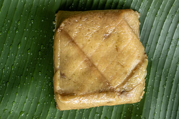 Chung cake, wrapped with dong leaves and bamboo chips, Vietnamese traditional Chung cake with dong...