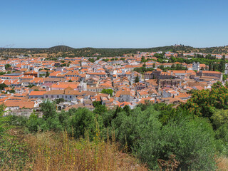 Fototapeta na wymiar Panoramic view of Montemor-o-Novo city. Traditional Portuguese town in the Évora District. Streets, squares, churches, ruins of castle are popular tourist destination.