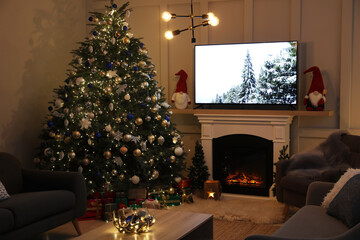 Cozy living room interior with beautiful Christmas tree near fireplace