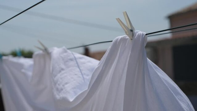 Drying bed sheets outdoor in hot summer air