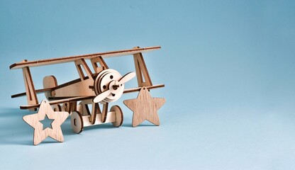 The wooden stars is the symbol of the army. The plane with wood stars on blue background. February 23, 9 may concept. Copy space. Greeting card for holiday