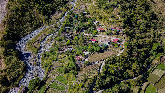 Aerial view of mountainous Kabayan in Benguet Philippines. Roads carve through the mountains along a river connecting communities business transpor