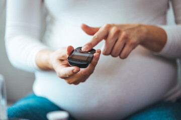 Diabetes monitoring with blood sugar test, glucose measurement on aged woman patient fingertip for analyzing insulin-deficient illness, diabetic disease awareness and control