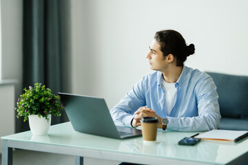 Young man working on laptop at office