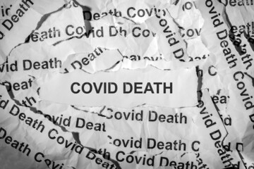 Several strips of paper labeled Covid death . Coronavirus concept.