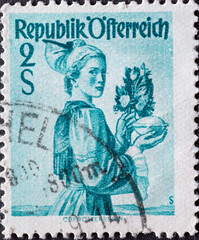 Austria - circa 1948: a postage stamp from Austria, showing a woman in national costume from the region: Upper Austria